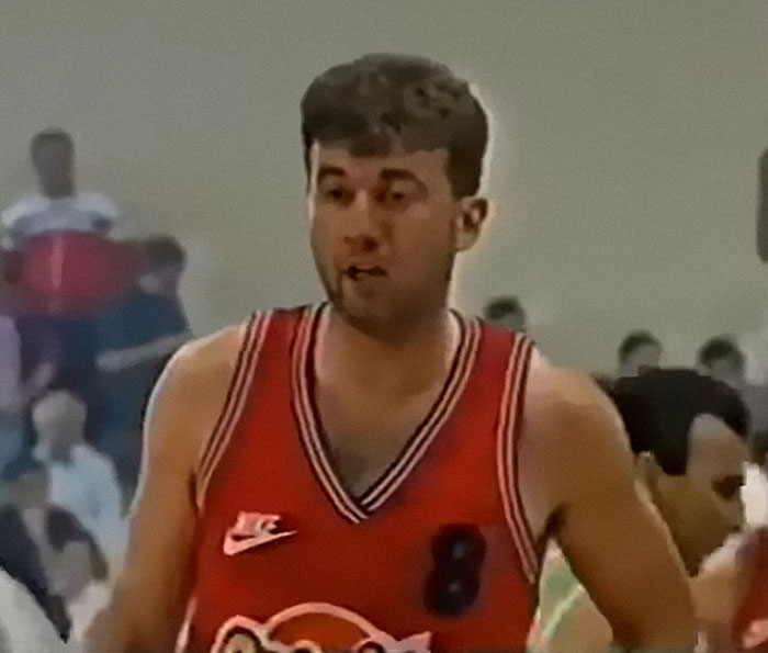 Young basketball player in red jersey on court, illustrating people who completely ruined their lives fast.