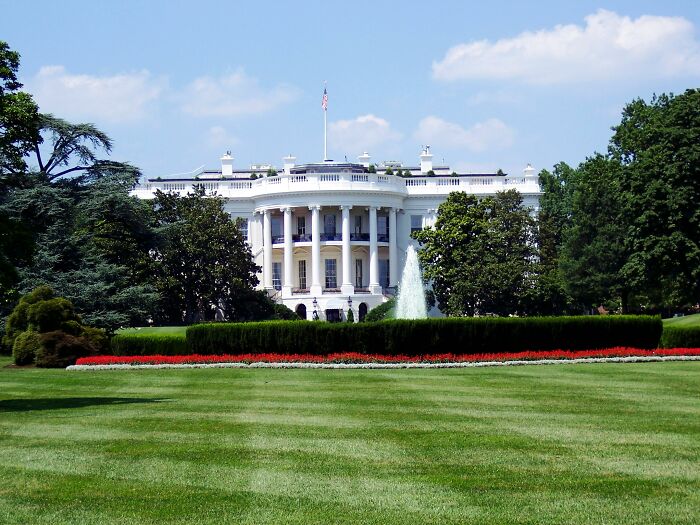 The White House with green lawn and fountain, symbolizing real-life stories of people becoming what they once hated.