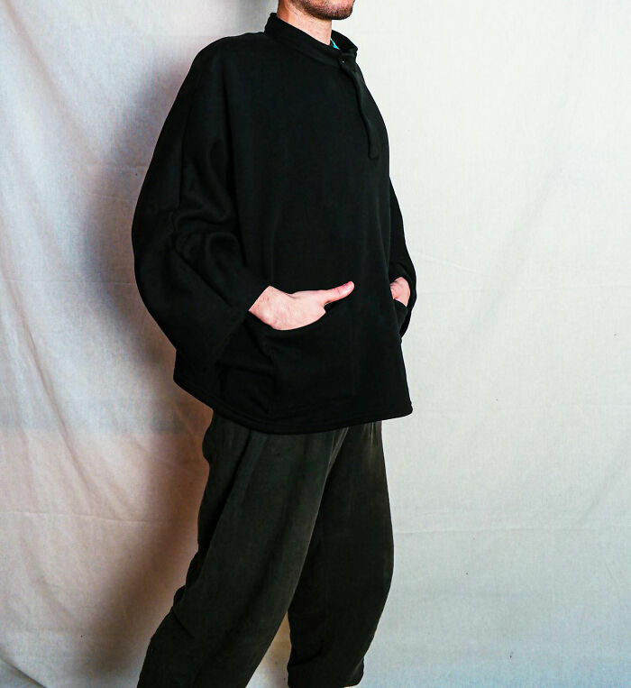 Person wearing all black casual outfit with hands in pockets, illustrating concept of people who got fired by their own dumb actions.