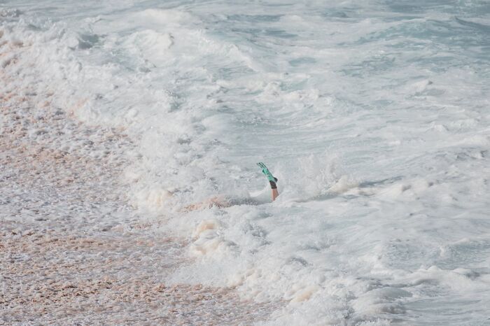 Person caught in rough ocean waves near shore, illustrating terrifying moments people thought were their last.