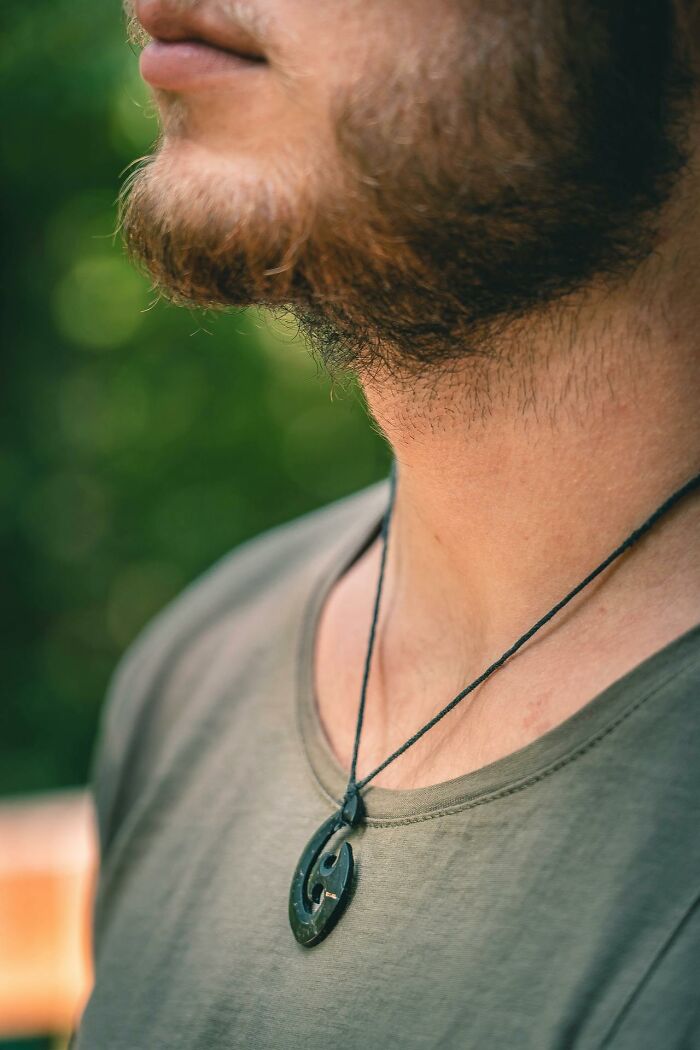 Close-up of a man’s beard and necklace, illustrating differences in things women are not allowed to do that men can do freely.
