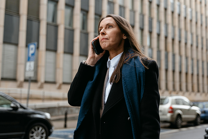 Woman in black coat talking on phone outdoors, reflecting shallow man&rsquo;s reaction to wife&rsquo;s new weight and lies exposed