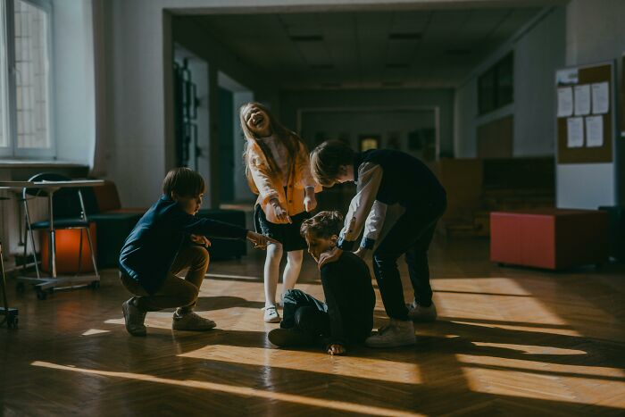 Children showing sweet facade while hiding manipulation and betrayal during a tense moment in a dimly lit room.