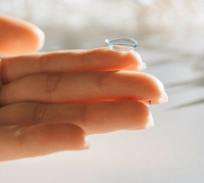 Contact lens resting on a fingertip, highlighting clear detail and focus, related to nasty things exes did.