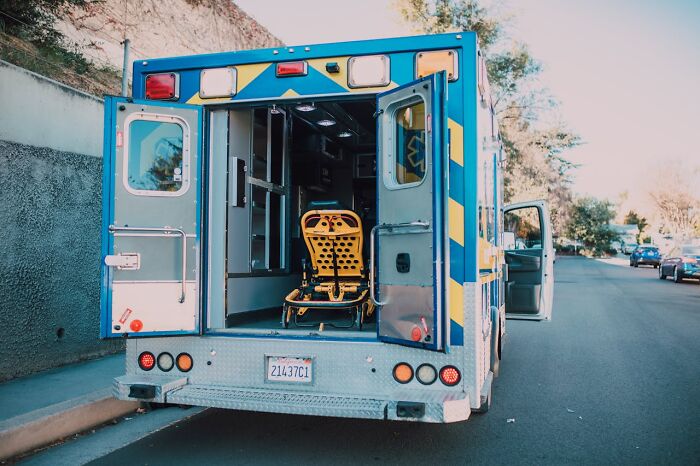 Rear view of an open ambulance with a stretcher inside, symbolizing the villain impact on someone's life story.