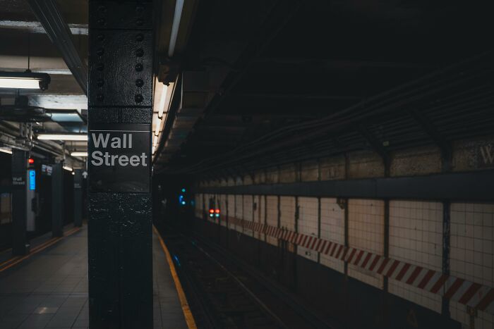 Dark underground subway platform with Wall Street sign, illustrating terrifying true stories from people working beneath our feet.