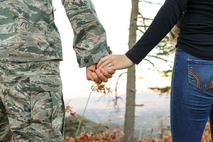 Couple holding hands outdoors, illustrating men who married out of pressure sharing their life updates and relationship outcomes.