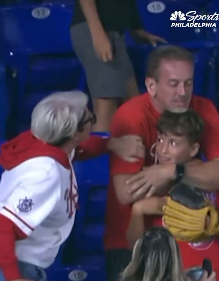 Woman grabbing home run ball from boy&rsquo;s hands at baseball game as company offers $5K with a catch involved.