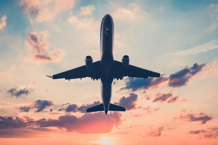 Airplane flying at sunset with dramatic sky, illustrating family eyes passenger's paid seat conflict during journey.