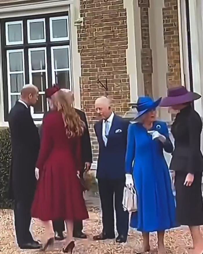 Royal family members in formal attire outside a brick building highlighting Princess Charlotte&rsquo;s curtsy mistake and Camilla's gesture.
