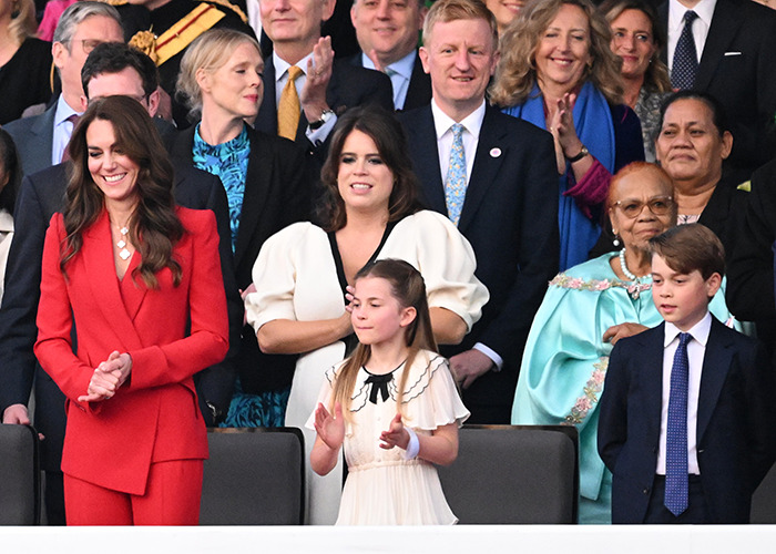 Princess Charlotte standing among royal family members as her curtsy mistake attracts attention in a public event.