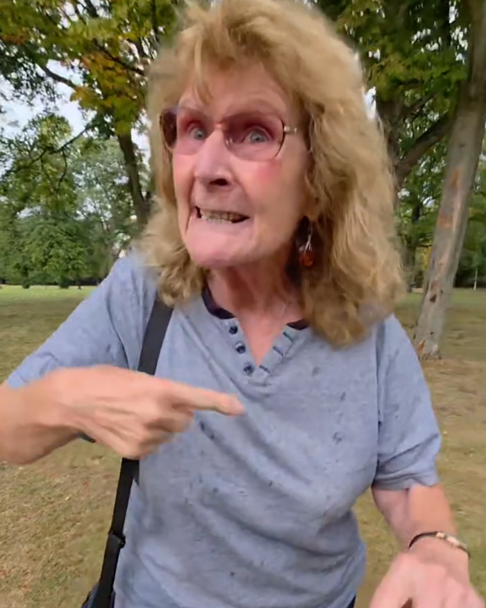Angry woman in a UK park gesturing and speaking intensely amid racial assault outrage against Filipino nurse. Angry woman in a UK park gesturing and speaking intensely amid racial assault outrage against Filipino nurse.