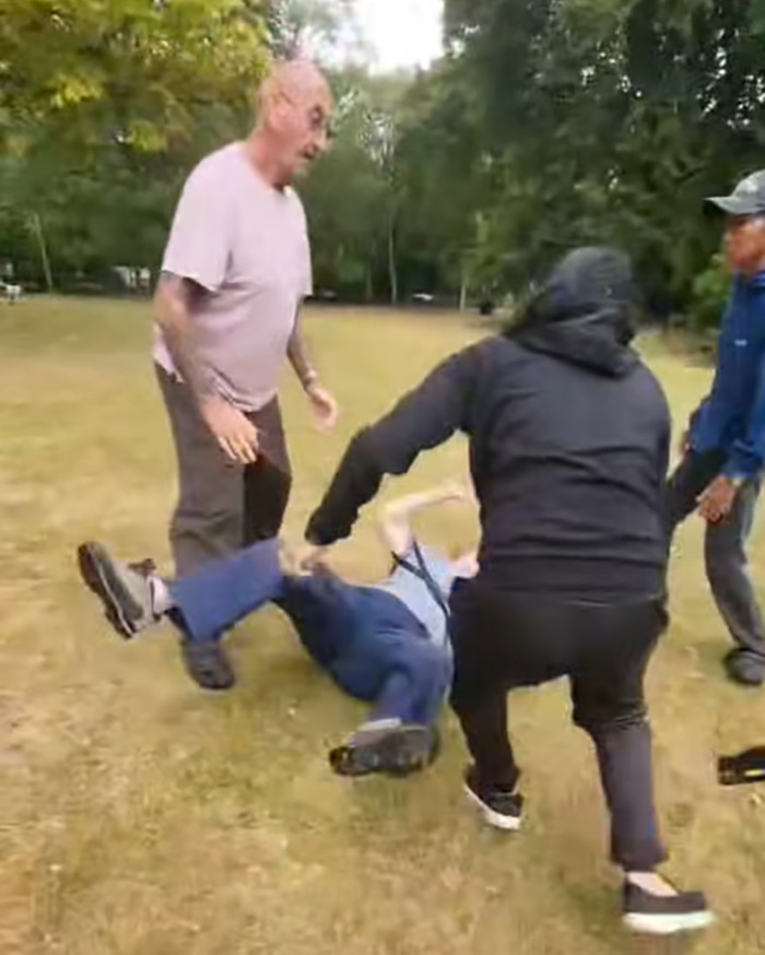 Man in park attacking another person on ground as racial assault against Filipino nurse in UK park sparks outrage. Man in park attacking another person on ground as racial assault against Filipino nurse in UK park sparks outrage.