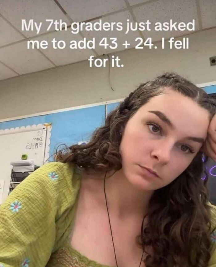 Young woman with curly hair resting her head on her hand, appearing tired, with a meme about 7th graders and math addition.