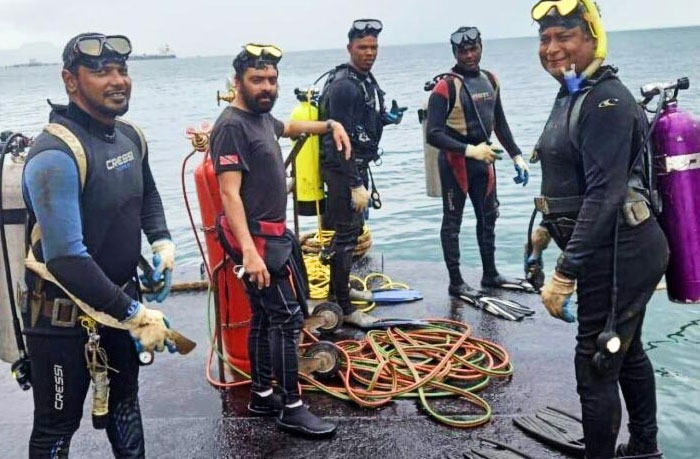 Group of divers in wetsuits preparing for a real-life underwater mission, evoking scary and thrilling stories.