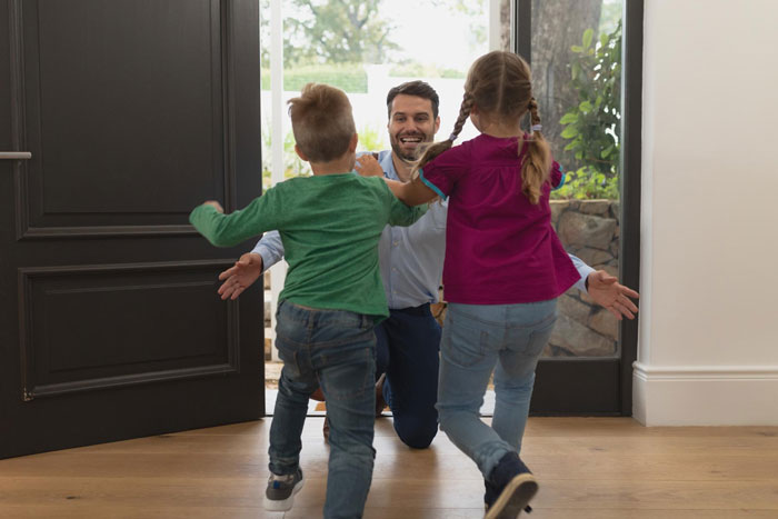Man happily welcoming children at home, illustrating refusing look after brothers children and family responsibility concept. Man happily welcoming children at home, illustrating refusing look after brothers children and family responsibility concept.