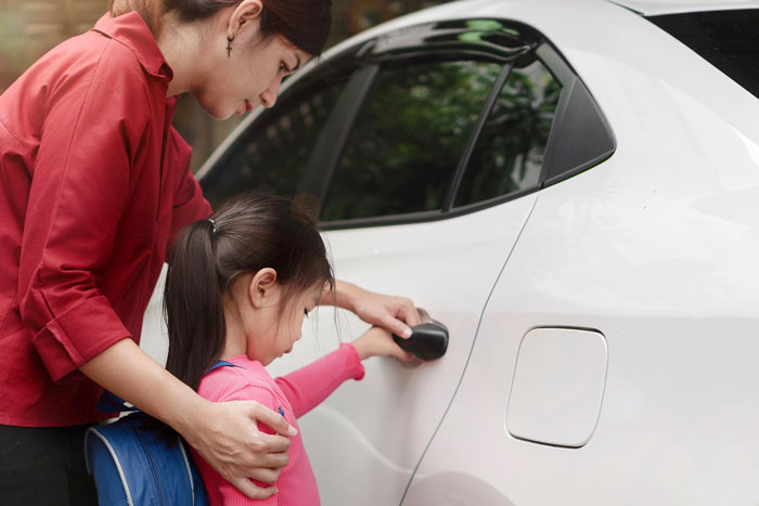 Woman showing refusal to pick up child from car door, illustrating conflict with cheating guy over affair kid responsibility. Woman showing refusal to pick up child from car door, illustrating conflict with cheating guy over affair kid responsibility.