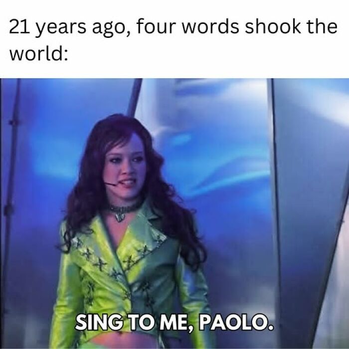 Woman in a bright green jacket performing on stage with caption about a memorable couple thing phrase from 21 years ago.