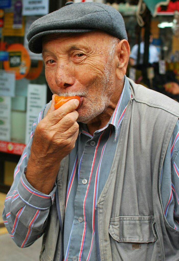 Elderly man wearing a cap eating fruit outdoors, illustrating a rare disease patient encounter in a medical context.