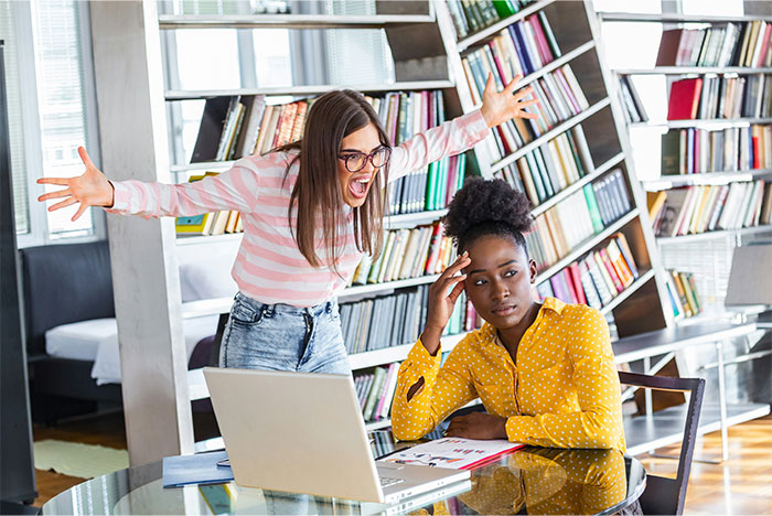 Angry woman yelling at coworker sitting at table frustrated over lunch space in office fridge issue. Angry woman yelling at coworker sitting at table frustrated over lunch space in office fridge issue.