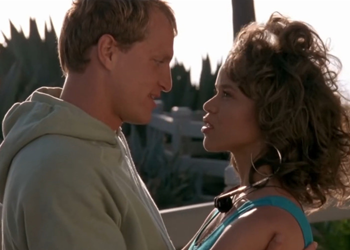 Rosie Perez and Woody Harrelson in an intimate film scene discussing body comments during filming.