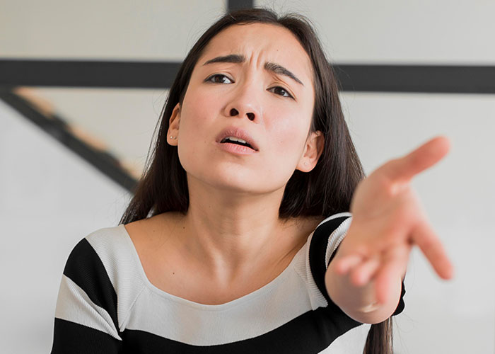 Woman looking upset and frustrated during a tense conversation about years of rude comments from mother-in-law