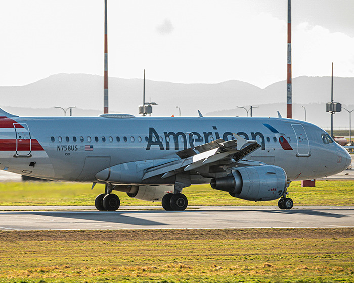 American Airlines plane taxiing on runway, symbolizing entitled passenger incident involving being kicked off flight. American Airlines plane taxiing on runway, symbolizing entitled passenger incident involving being kicked off flight.