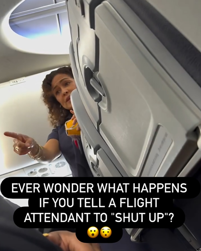 Flight attendant pointing inside airplane cabin at an entitled passenger kicked off flight for telling attendant to shut up. Flight attendant pointing inside airplane cabin at an entitled passenger kicked off flight for telling attendant to shut up.