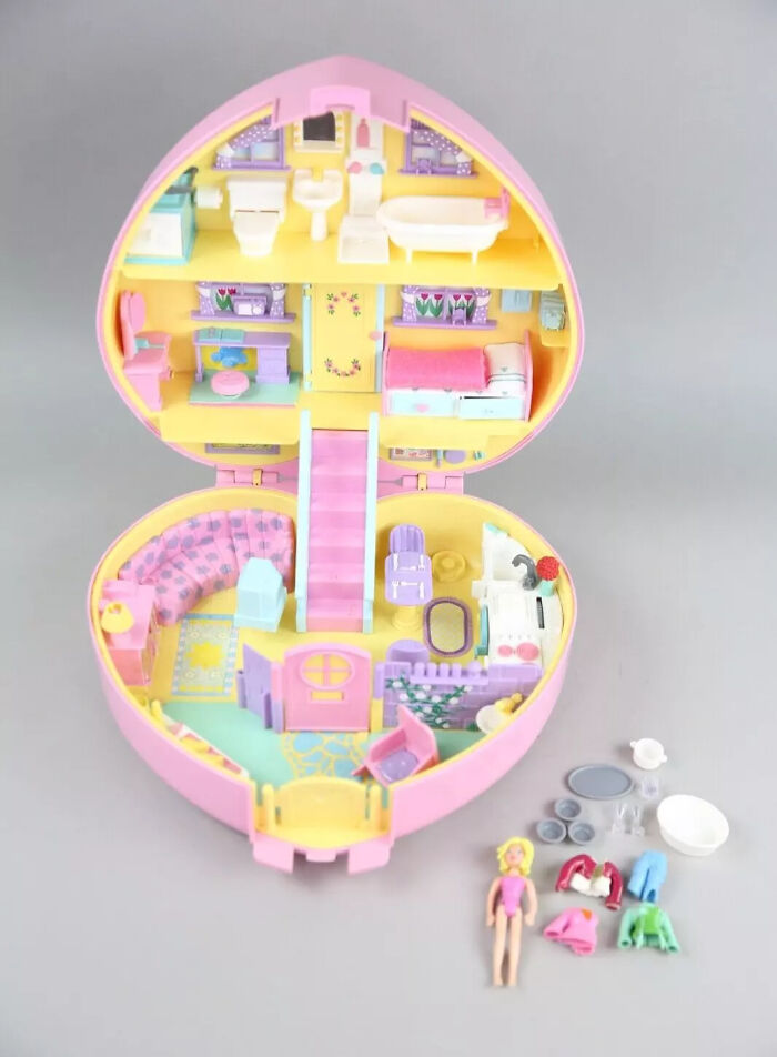 Vintage toys worth fortune shown as a pastel-colored miniature dollhouse with detailed rooms and tiny accessories.