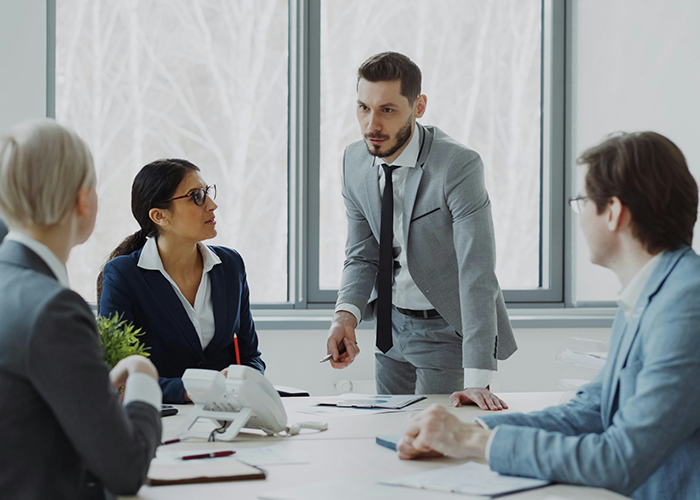 Business team in a meeting discussing server down issues during business hours with concern over malicious compliance. Business team in a meeting discussing server down issues during business hours with concern over malicious compliance.