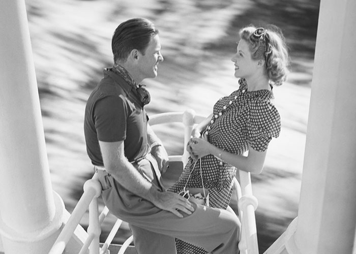 Vintage black and white photo of a couple smiling and leaning close, evoking themes of dark secrets in family relationships.