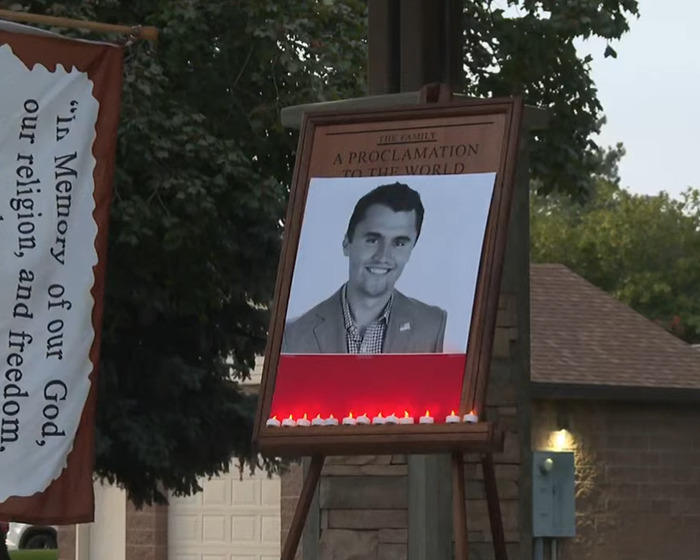 Memorial setup featuring a photo of Charlie Kirk with candles, reflecting South Park viewers' reaction to the eerie episode.