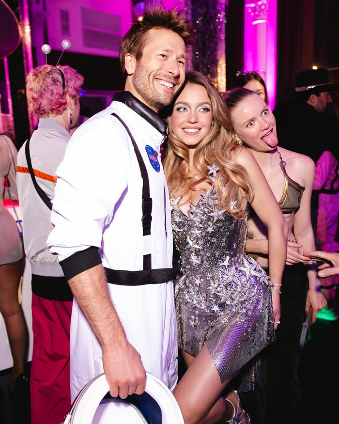 Sydney Sweeney in a sparkling outfit recreating iconic Britney Spears look at a lively birthday party with friends.