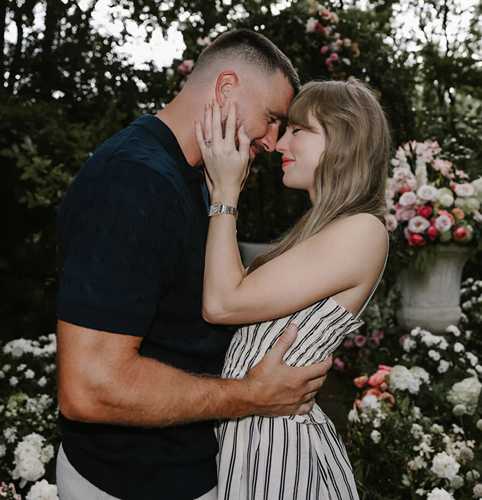 Couple embracing outdoors surrounded by flowers, illustrating a moment connected to Taylor Swift wedding discussion.