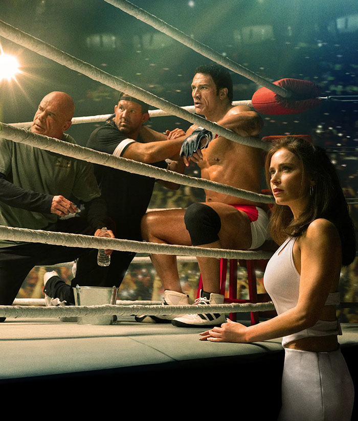 Dwayne Johnson in boxing ring corner with trainers and a woman nearby as fans defend actor&rsquo;s slim look health concerns.