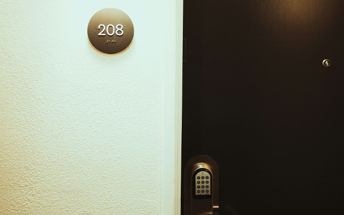 Door 208 with a keypad lock illustrating security measures related to things men do that affect women's feeling safe or threatened.