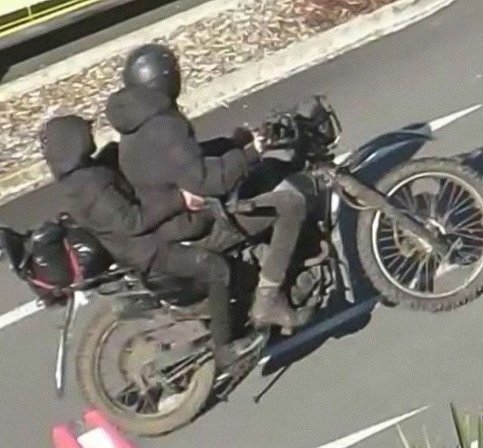 Two people in dark clothing riding a motorcycle related to mom of kids who vanished into wilderness case