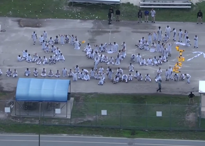 Aerial view of detainees at Alligator Alcatraz facility gathered outdoors, highlighting concerns about missing ICE records.