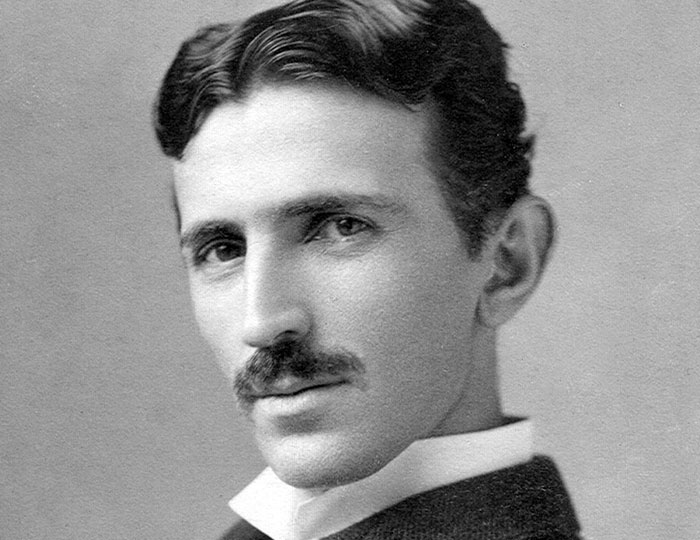 Black and white portrait of Nikola Tesla, a key figure in bizarre and fascinating historical events and inventions.