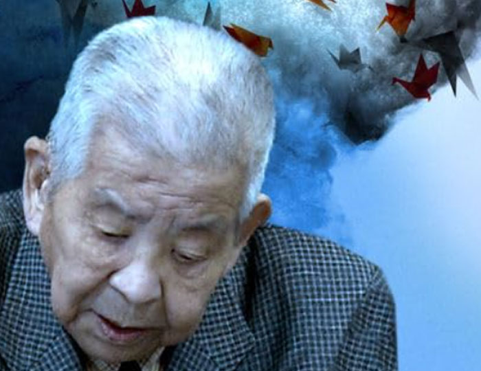 Elderly man with white hair appears deep in thought against a blue background with origami birds, depicting historical events.