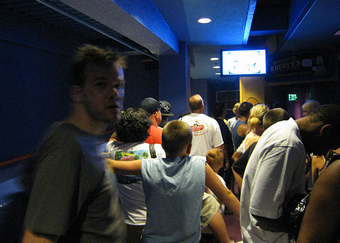 Crowded dimly lit hallway with tired vacationers, illustrating stressful trips and vacations that felt like a nightmare experience.