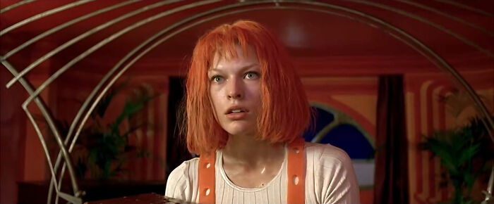 Female character with bright orange hair in a vibrant setting, representing well-written female characters in movies.