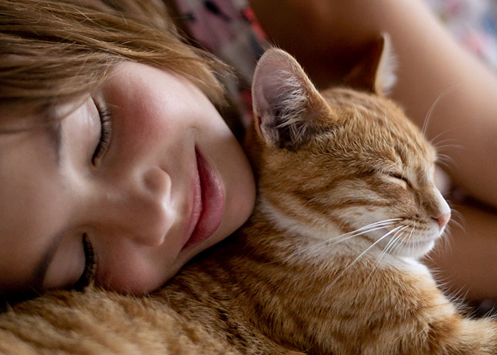 Child resting peacefully with a cat, reflecting on wildest rules people grew up with and childhood memories.