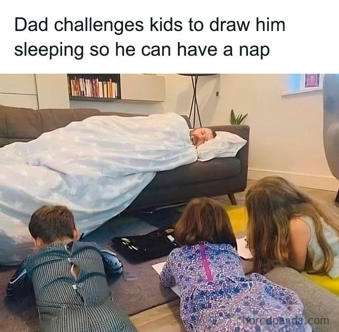 Dad wrapped in blanket napping on sofa while kids draw him, capturing wholesome moments of dads doing their best parenting.