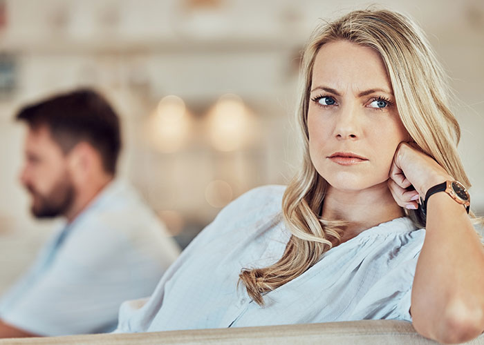 Worried man and upset wife in a tense moment, highlighting relationship drama risking job and marriage.