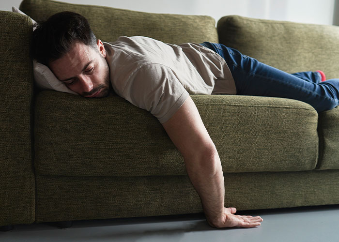 Man lying exhausted on a green couch, illustrating a husband with a real problem needing an exit plan. Man lying exhausted on a green couch, illustrating a husband with a real problem needing an exit plan.