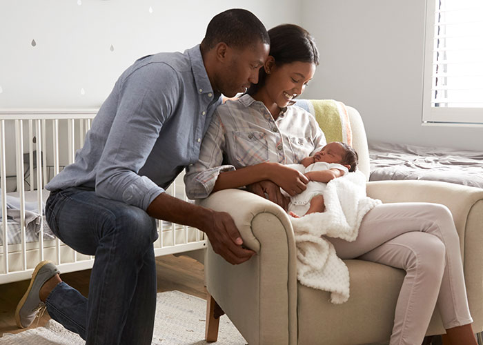 Mom and husband in nursery with newborn, focusing on parenting challenges and building an exit plan together. Mom and husband in nursery with newborn, focusing on parenting challenges and building an exit plan together.