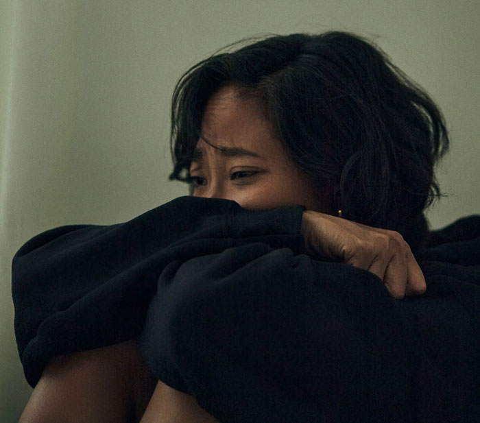 Woman sitting alone, looking distressed and crying, reflecting emotions after a stand-up show experience. Woman sitting alone, looking distressed and crying, reflecting emotions after a stand-up show experience.