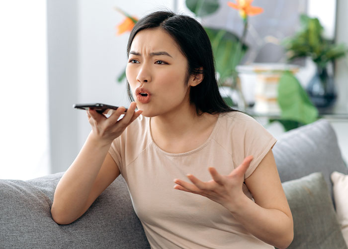 Woman forbids brother-in-law from talking to her, expressing frustration while speaking into a phone at home.