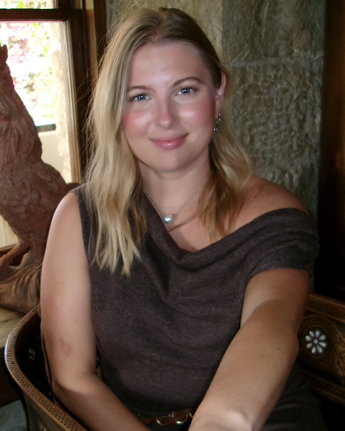 Woman with blonde hair smiling indoors, symbolizing woman solving friend's medical mystery after multiple doctors failed. Woman with blonde hair smiling indoors, symbolizing woman solving friend's medical mystery after multiple doctors failed.